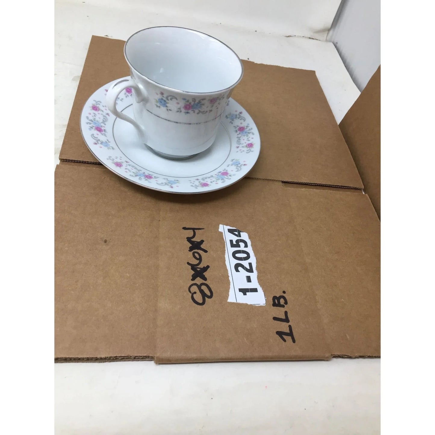 F.T.D.A 1987 Teacup and Saucer Set with Pink/Blue Flowers printed on both F.T.D.A A+ Stuff