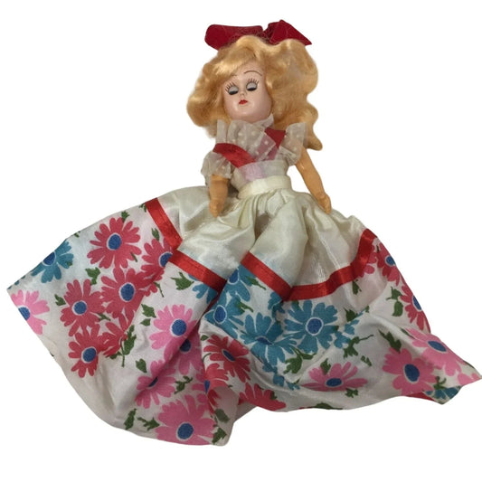 Vintage Collectible Doll With Blonde Hair wearing floral printed dress/red bow A+ Stuff A+ Stuff