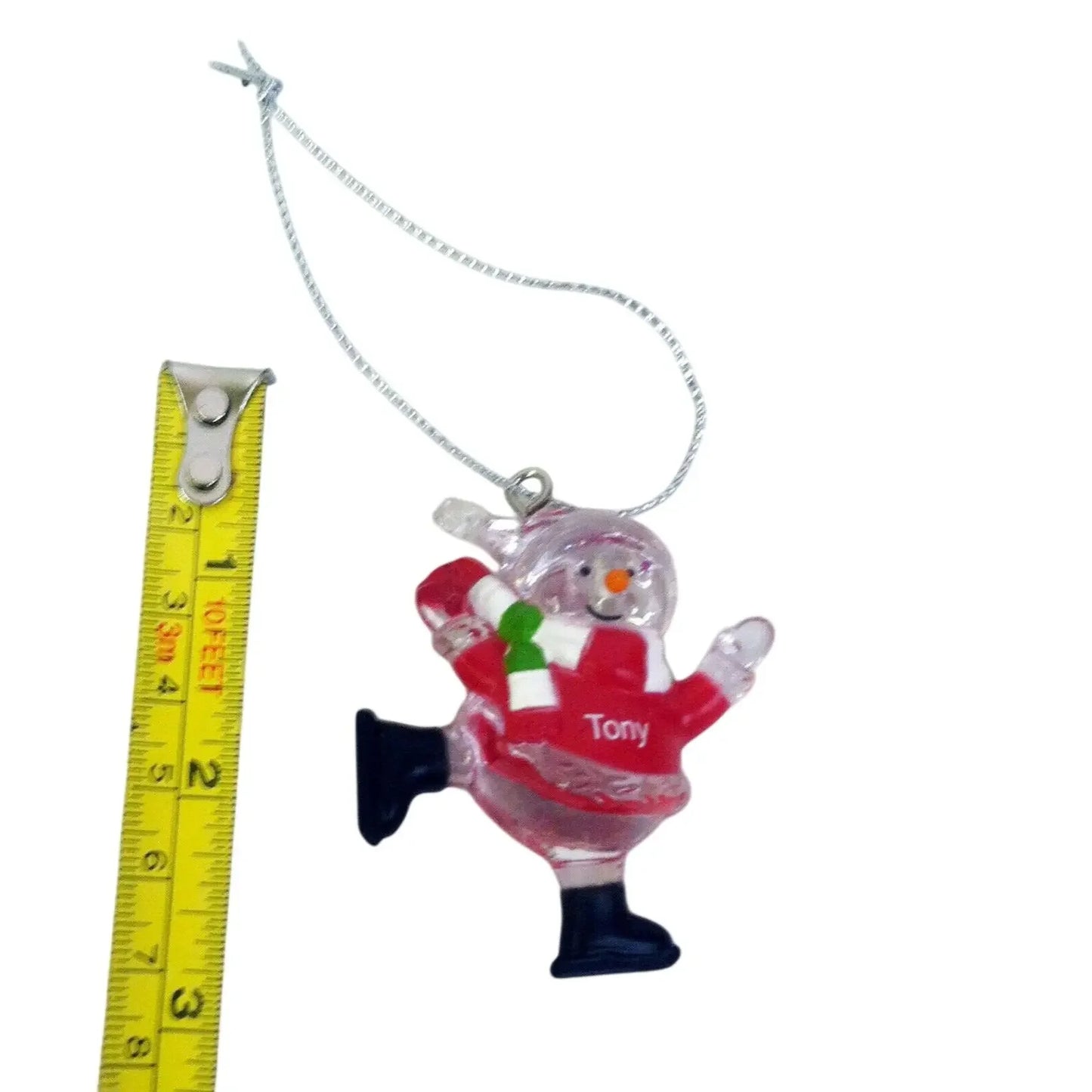 Personalized snowman Christmas ornament with red outfit, next to measuring tape