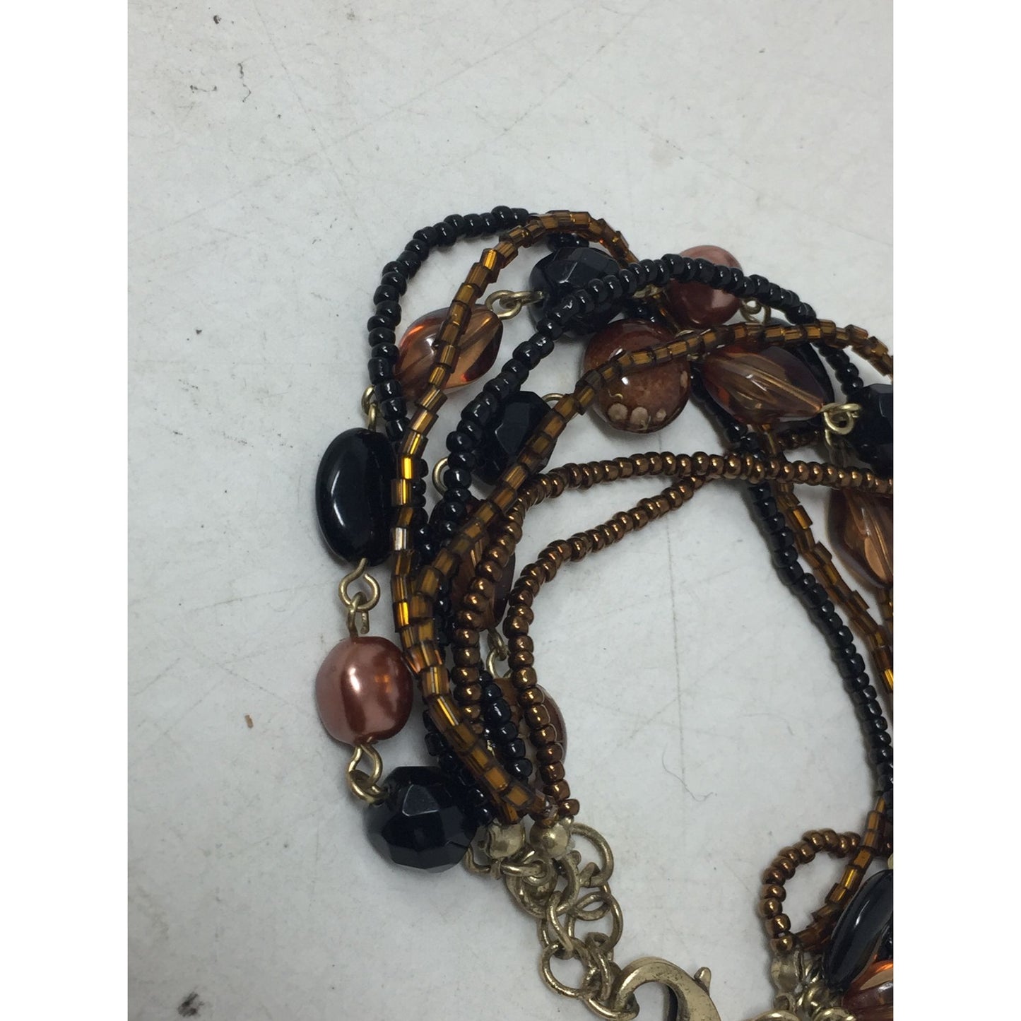 Lia Sophia Beautiful Gold Tone Multi Strand Bracelet with Brown/Black Beads