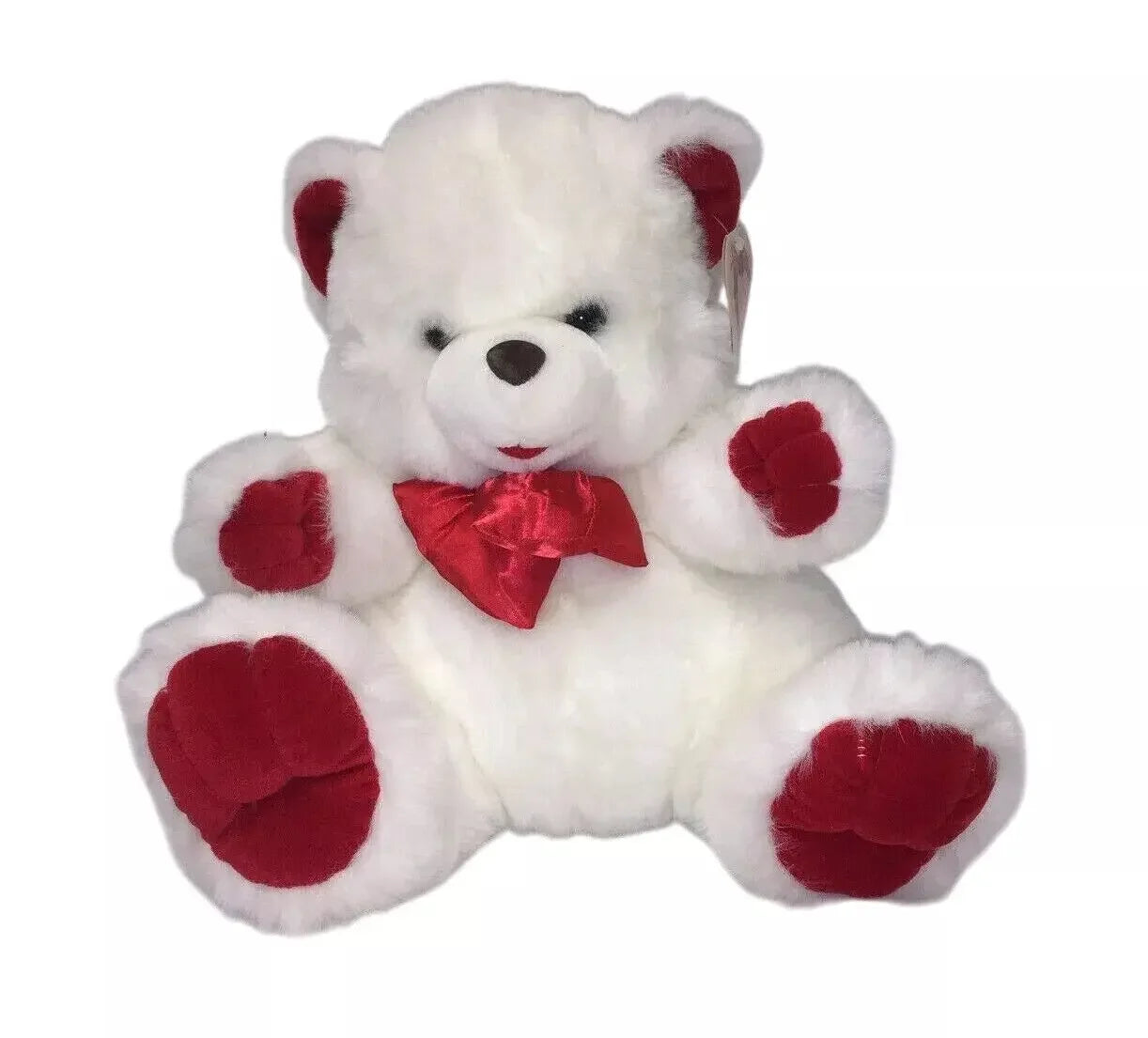 White teddy bear plush toy with red ears, paws, and a red bow on white background