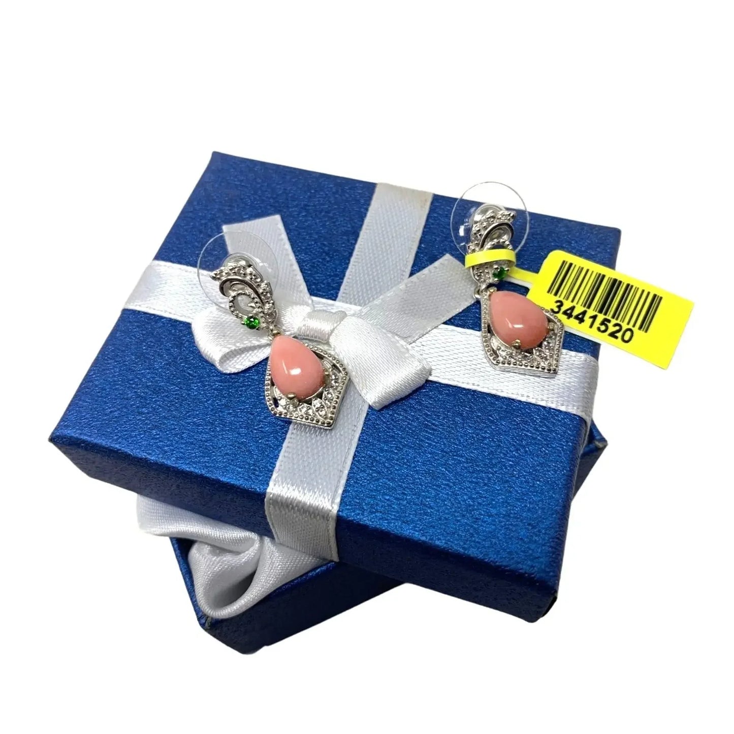 Silver and pink gemstone earrings displayed on blue gift box with white ribbon
