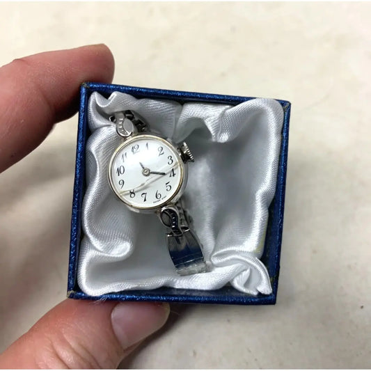 Silver ladies wristwatch with white dial in blue gift box on satin lining