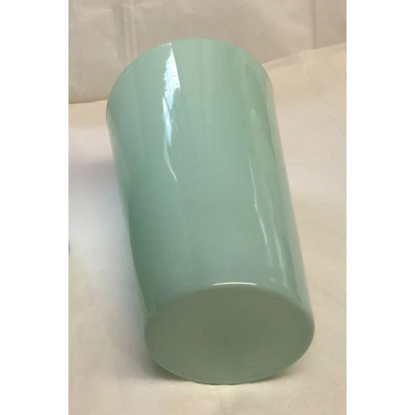 Light blue glossy cylindrical tumbler on a white background