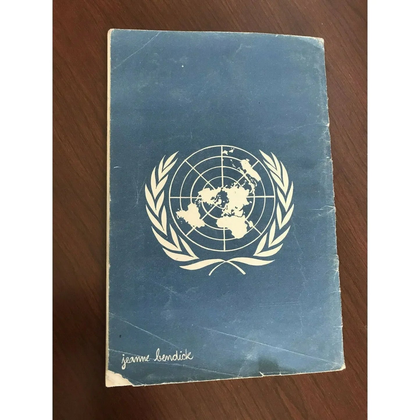 Worn blue booklet with white United Nations logo and Jeanne Bendick's signature on cover