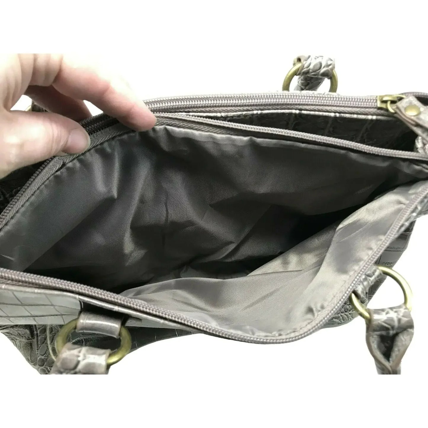 Hand opening gray faux leather purse with spacious zippered interior and gold hardware