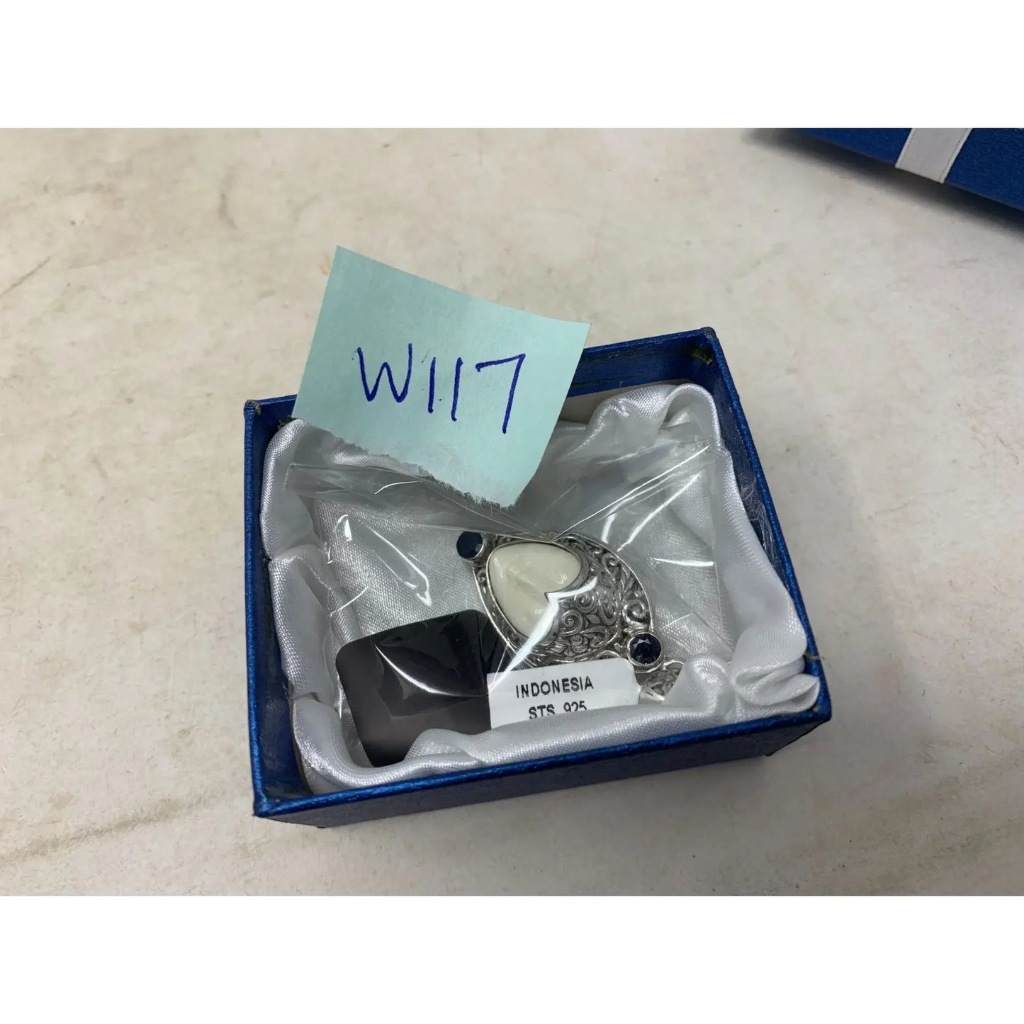 Sterling silver and stone pendant from Indonesia in blue gift box on white background