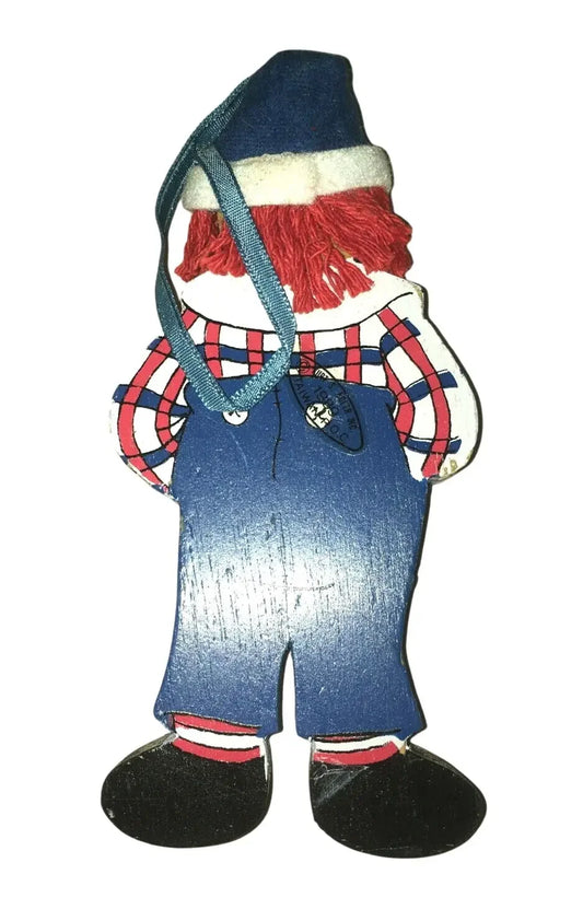 Vintage wooden doll ornament with red yarn hair, plaid shirt, blue overalls, and a blue hat