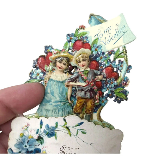Vintage Valentine card featuring children with flowers, hearts, and 'To my Valentine' banner.