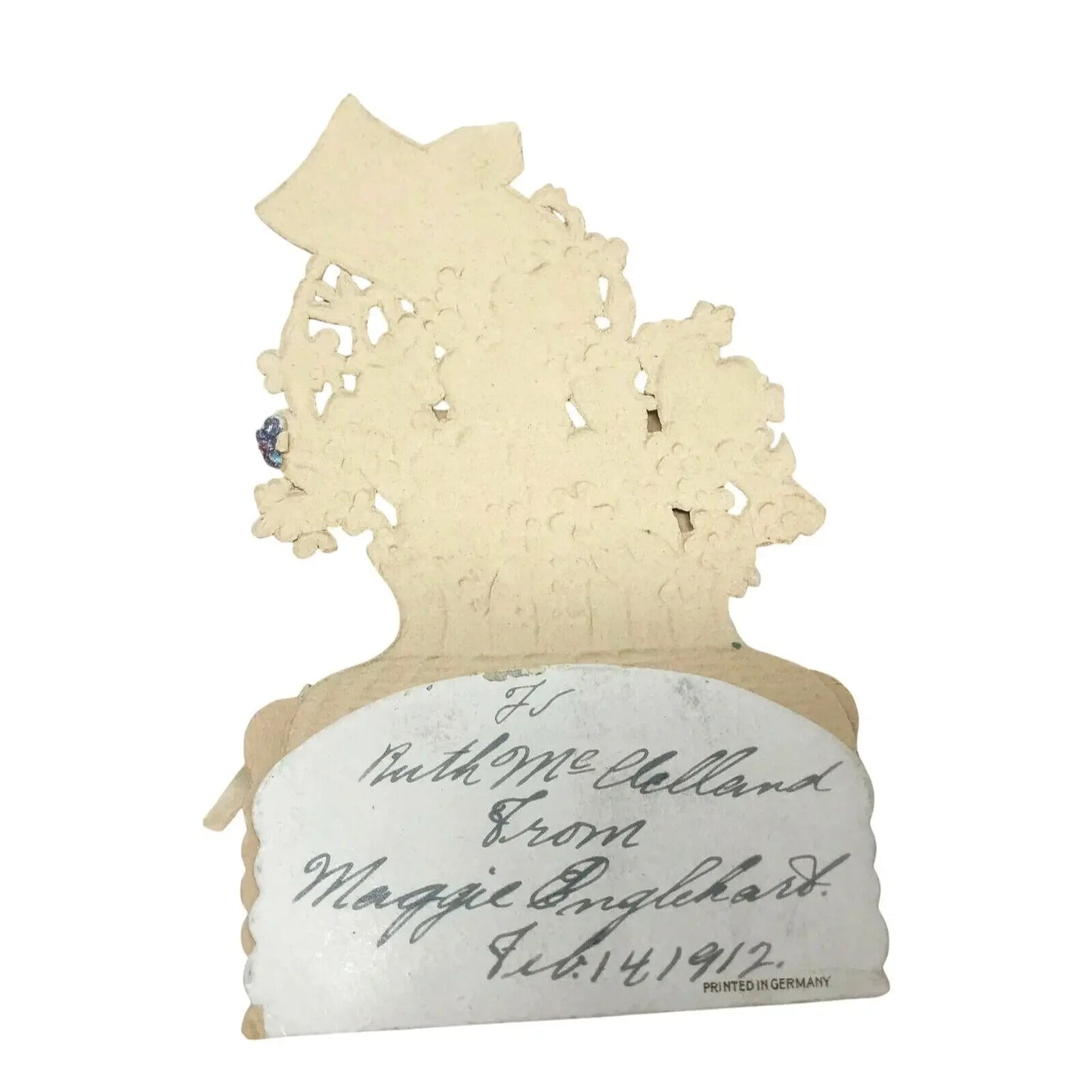 Vintage paper card with handwritten message and intricate floral cutout design, dated 1912.