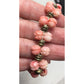 Women's Gold Tone Bracelet with Pink Flowers on it