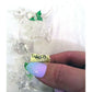 Hand holding vintage clear glass reindeer ornament with green leaf accents and Enesco label
