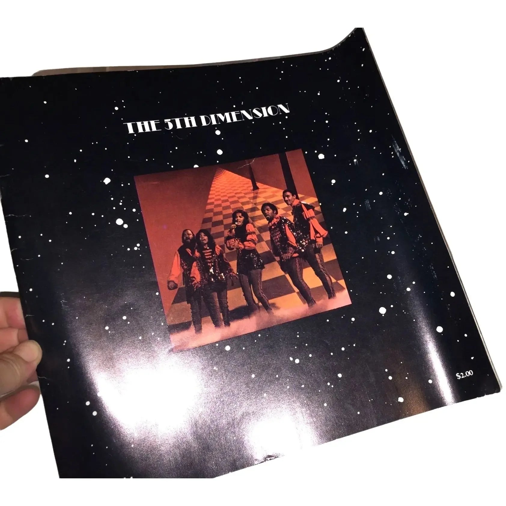 The 5th Dimension vinyl record cover with black starry background and band photo center
