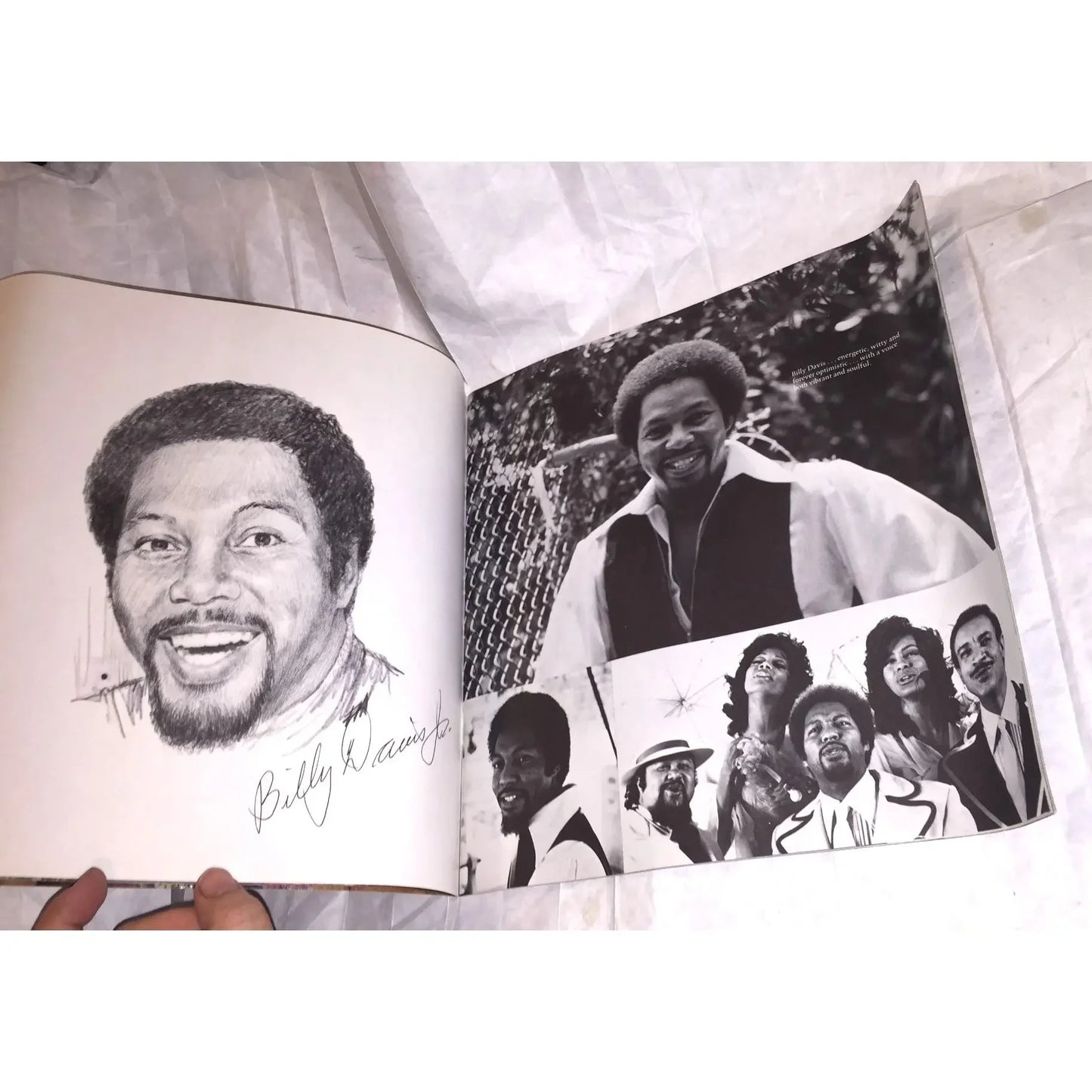 Open book showing a portrait sketch and black-and-white photos of a man and a musical group