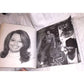 Open vintage photo book showing a pencil portrait and black and white photos of smiling women.