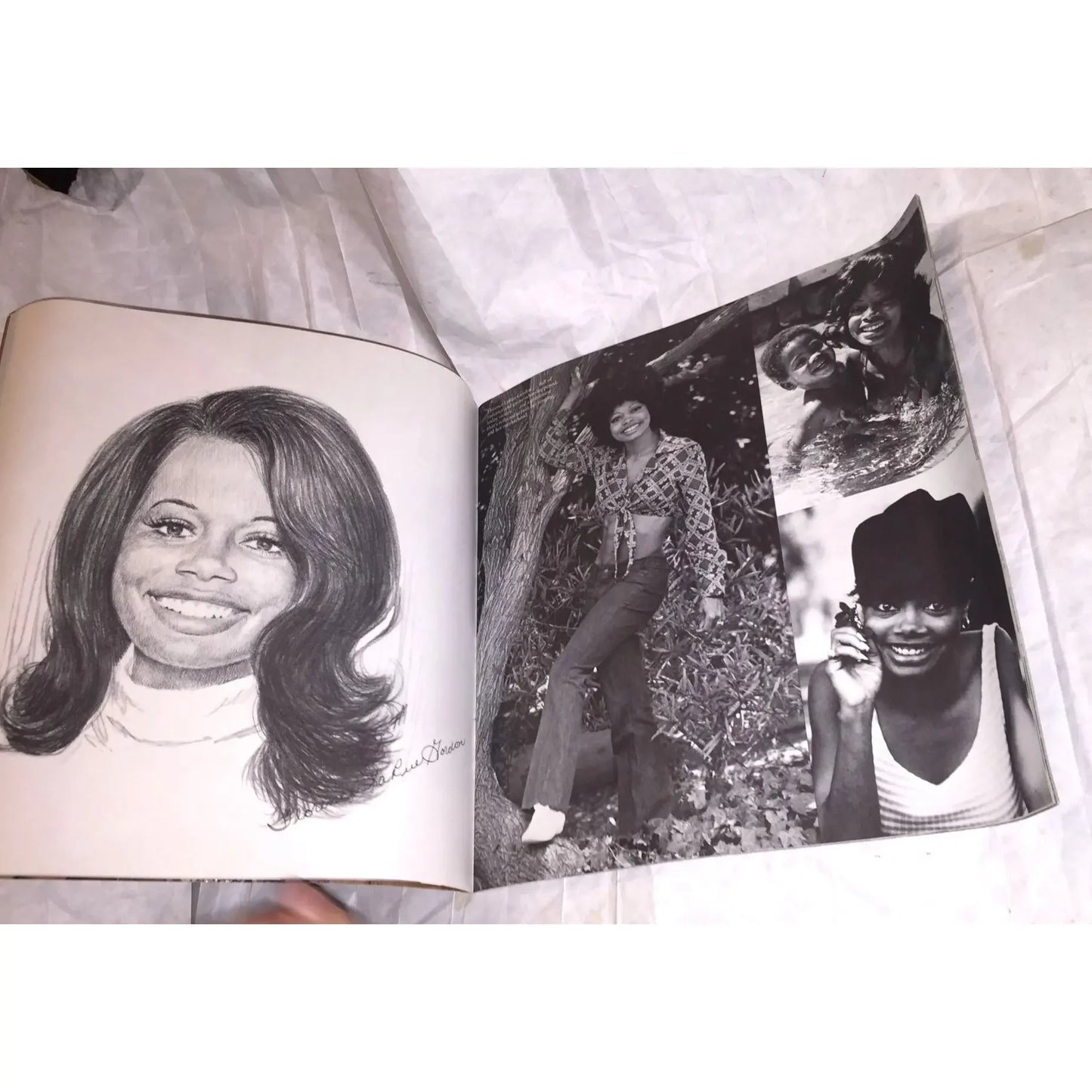 Open vintage photo book showing a pencil portrait and black and white photos of smiling women.