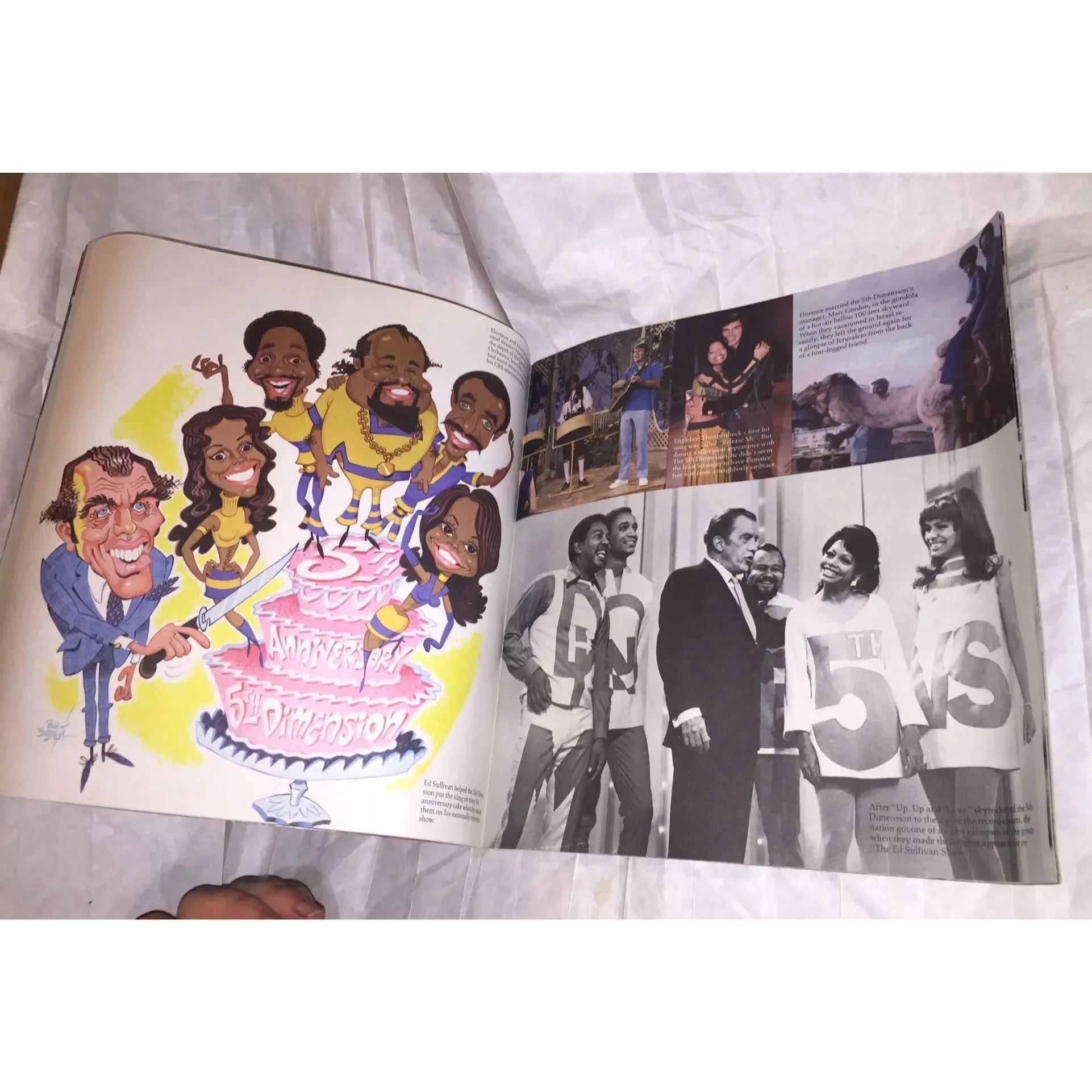 Open magazine showing colorful caricature illustration and black-and-white vintage photos.