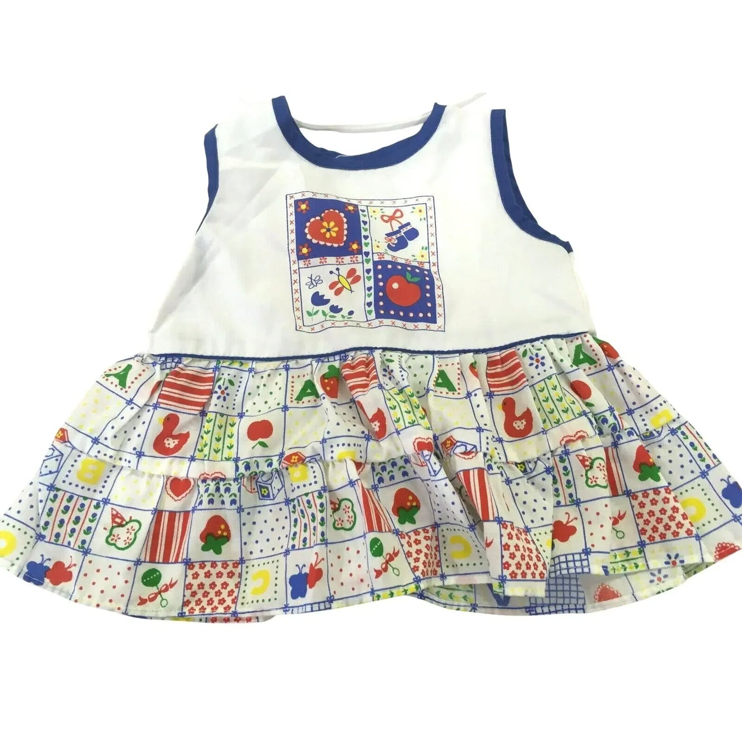 Colorful sleeveless toddler dress with playful patchwork print and blue trim, white bodice