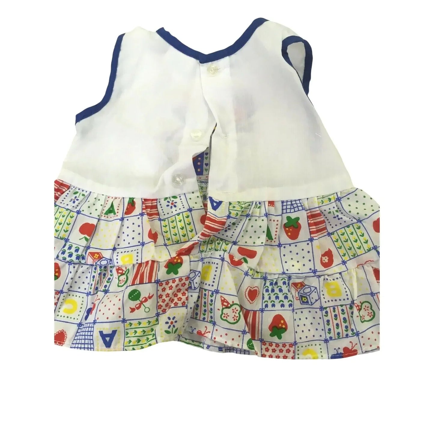 Children's sleeveless dress with white top and colorful patterned skirt featuring fruit and shapes