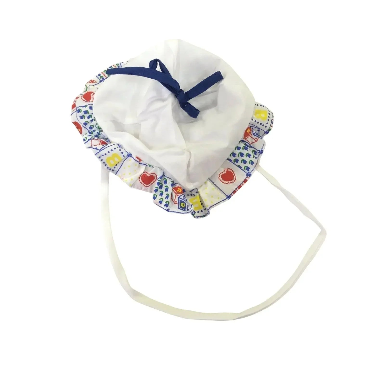 White baby bonnet with colorful patterned trim and blue ribbon on white background