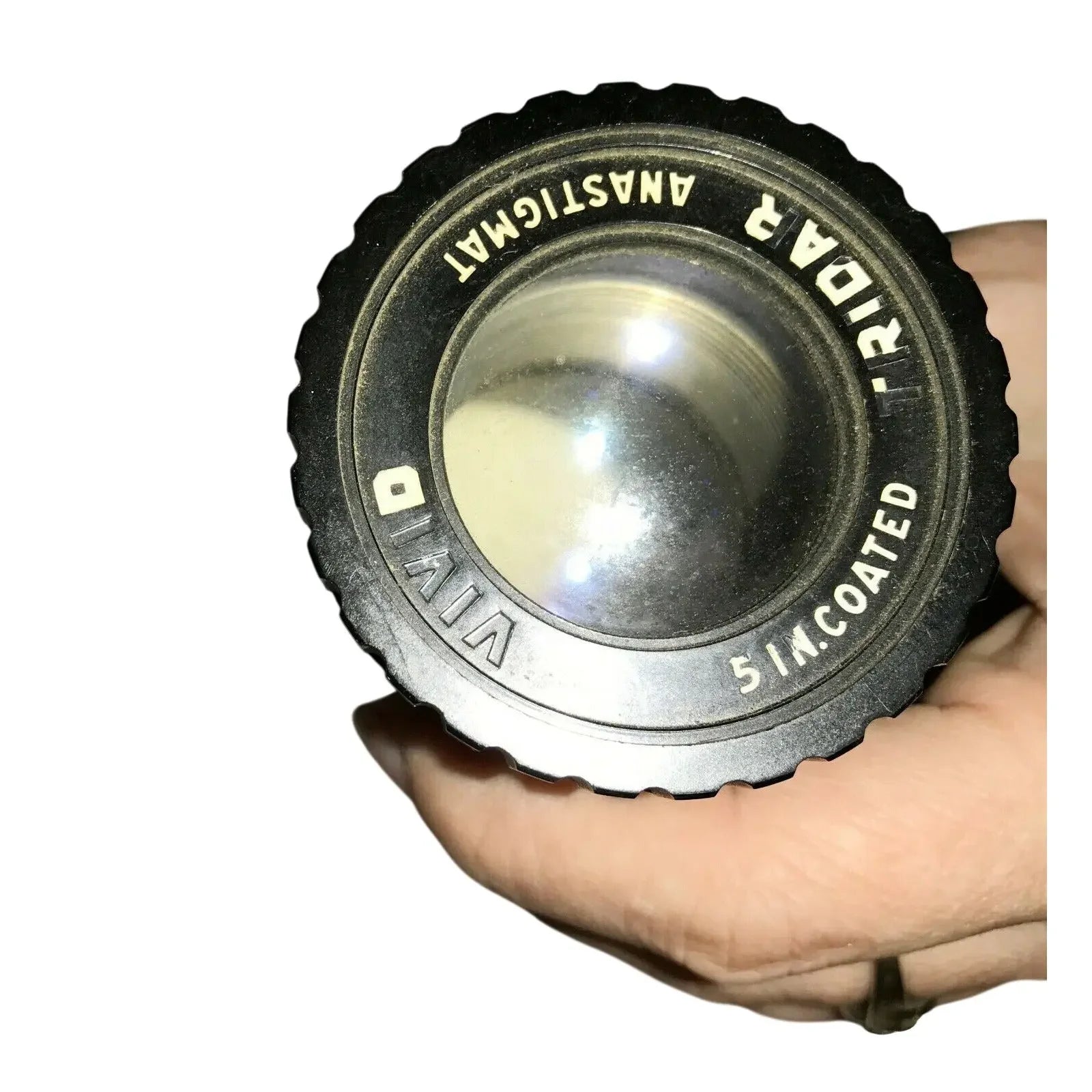 Hand holding a vintage Vivitar Tridar 5-inch coated camera lens, close-up view