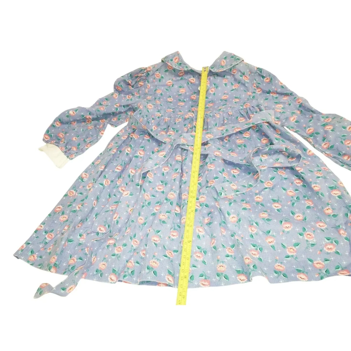 Blue floral long sleeve dress with a collar and measuring tape along the front