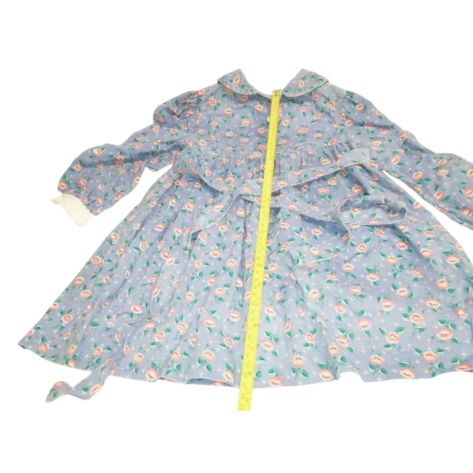 Blue floral long sleeve dress with a collar and measuring tape along the front