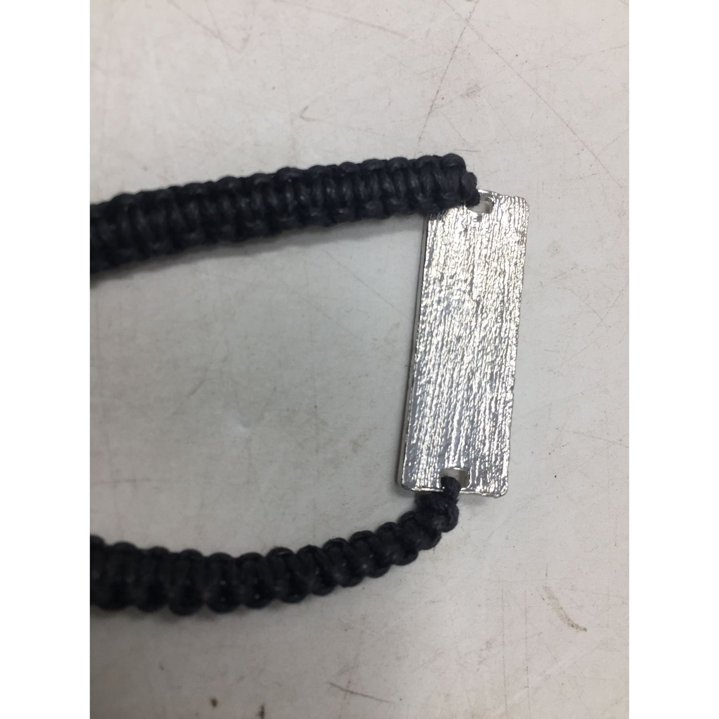 Black Bracelet with Silver Tone Pendant that says ''Music'' in Cursive