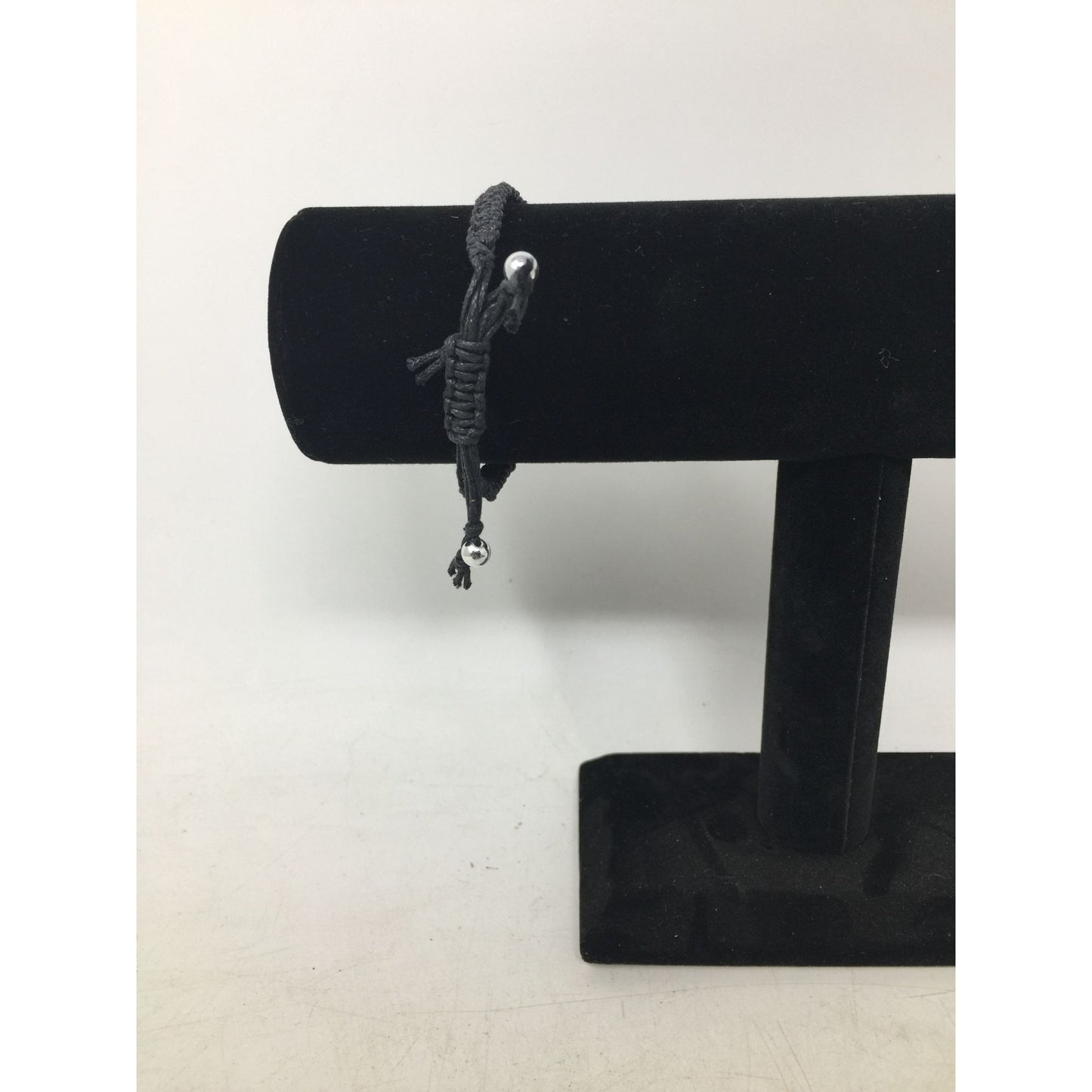 Black Bracelet with Silver Tone Pendant that says ''Music'' in Cursive