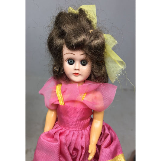 Vintage Collectible Doll Brown Hair, Blue Eyes wearing Pink, Blue, Yellow Dress