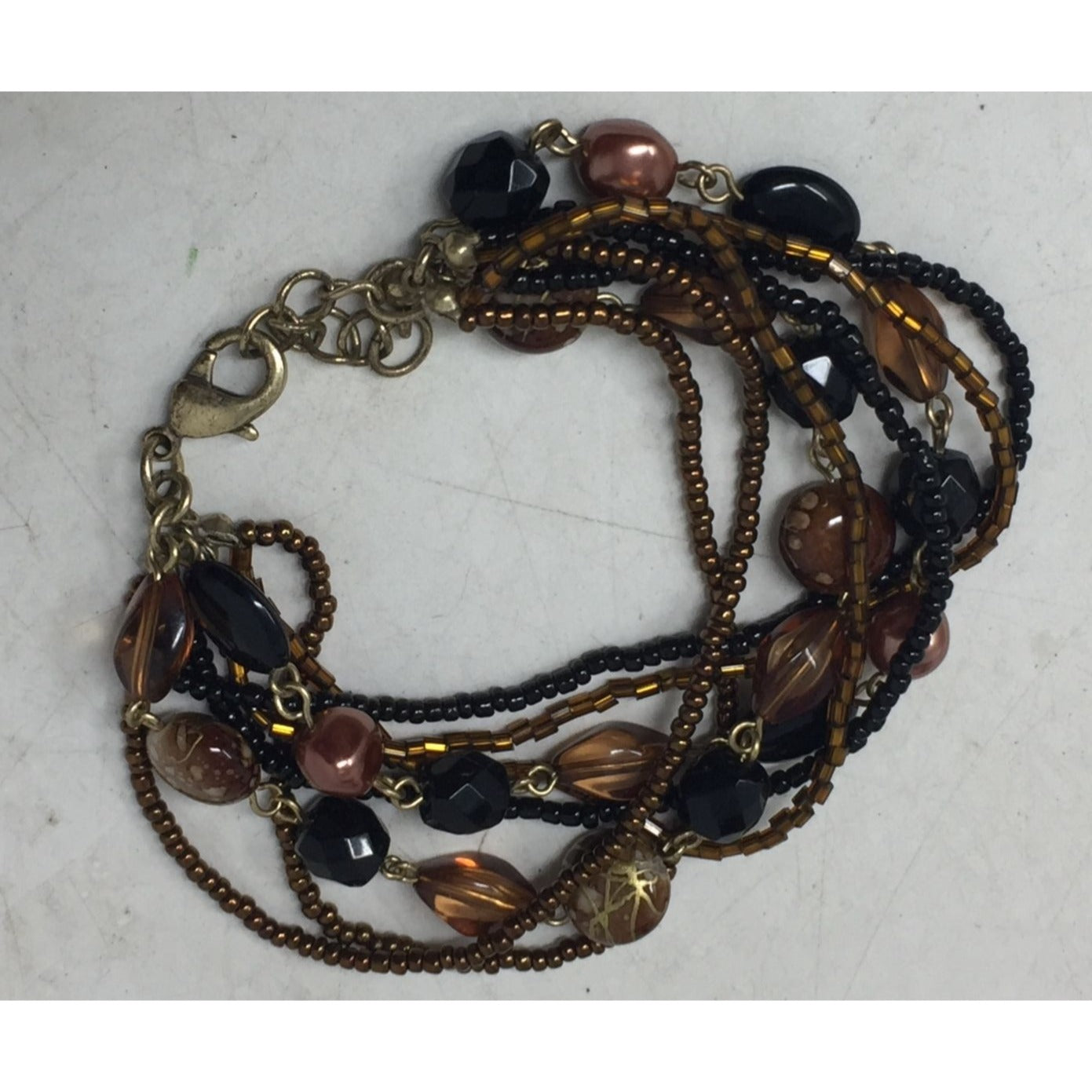 Lia Sophia Beautiful Gold Tone Multi Strand Bracelet with Brown/Black Beads