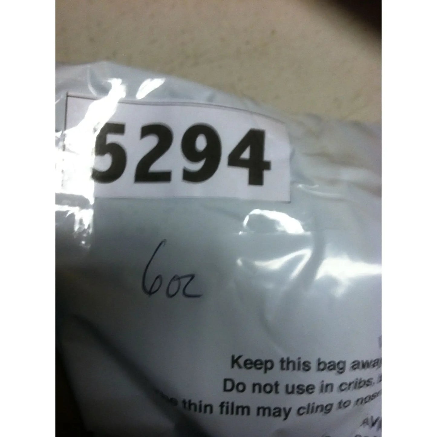 Plastic bag labeled 5294, handwritten 6oz, with warning text visible