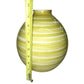 Yellow and white striped ceramic vase measured with a tape measure against a white background