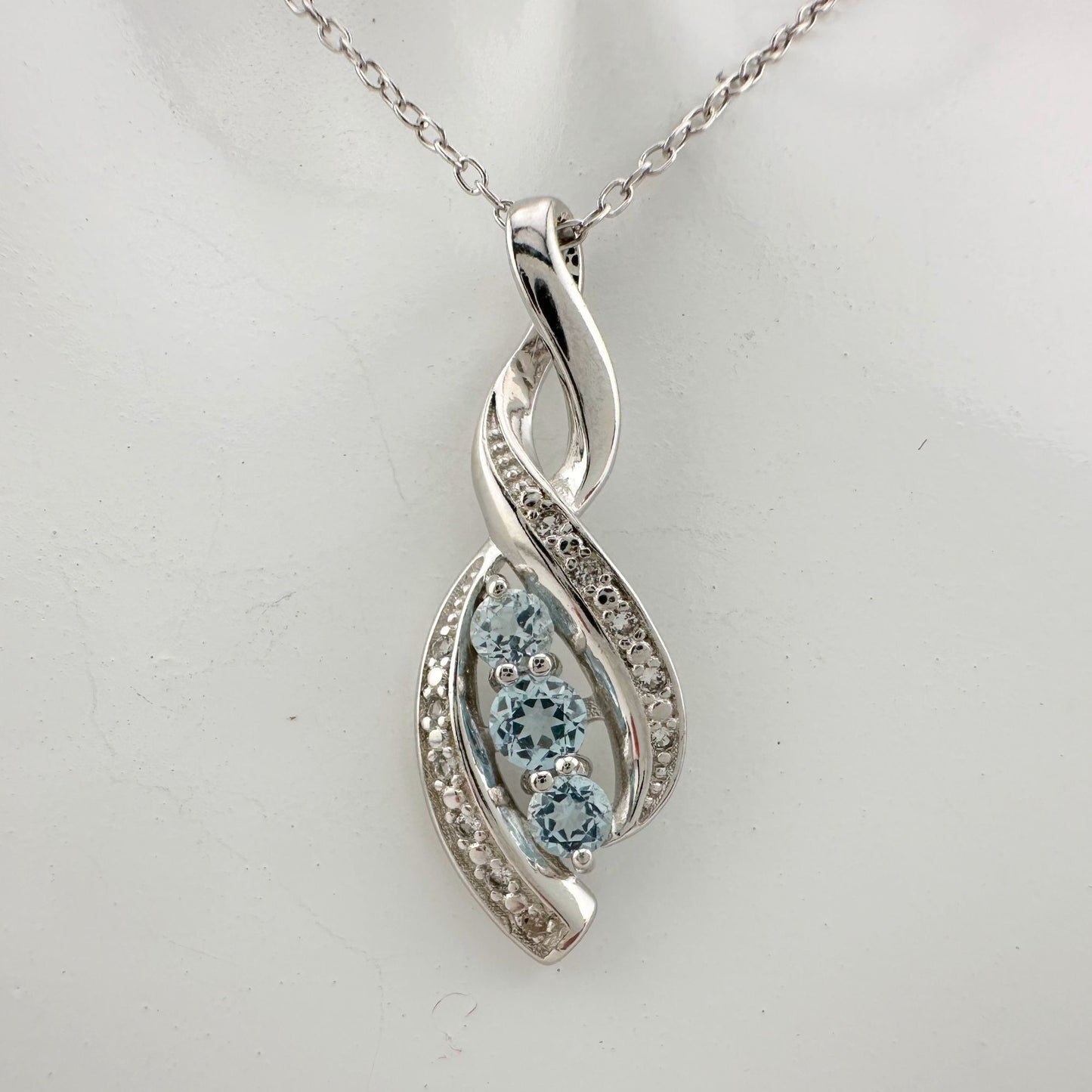 Blue Topaz Swirling Ribbon Necklace with Diamond Accent