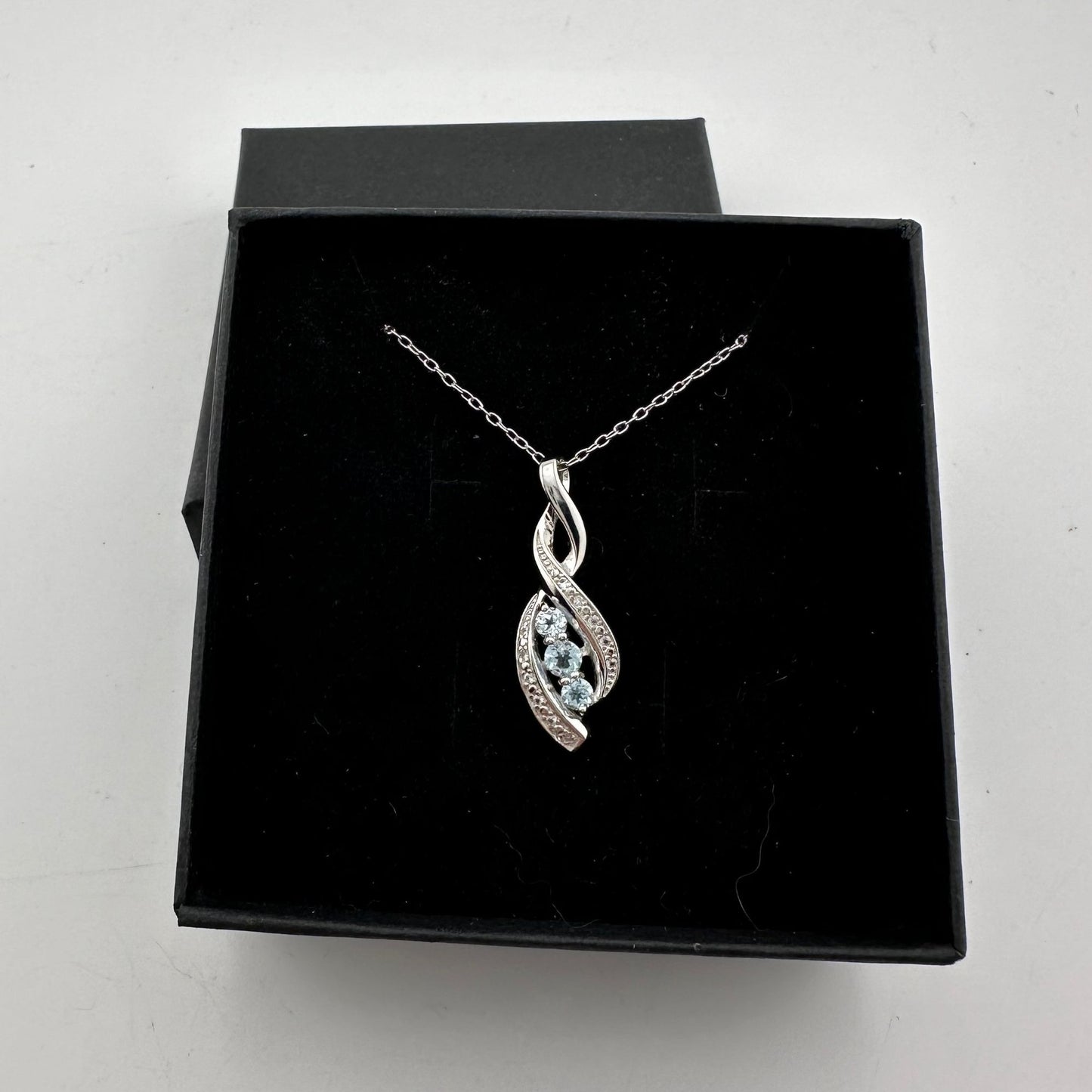 Blue Topaz Swirling Ribbon Necklace with Diamond Accent