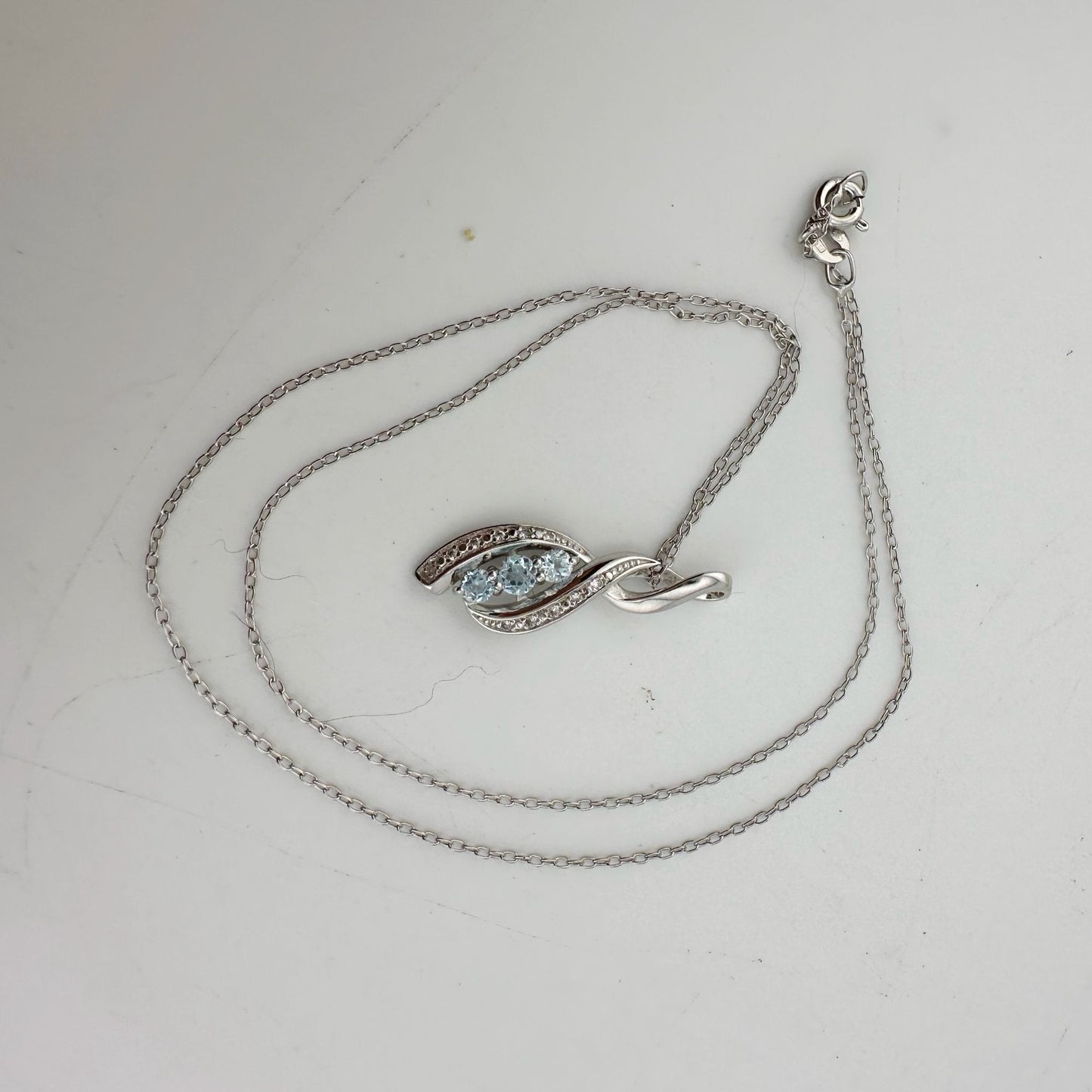 Blue Topaz Swirling Ribbon Necklace with Diamond Accent