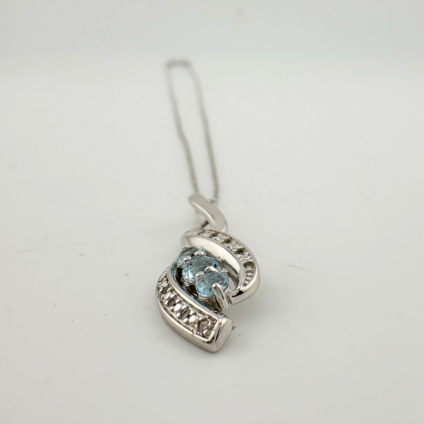 Blue Topaz Swirling Ribbon Necklace with Diamond Accent