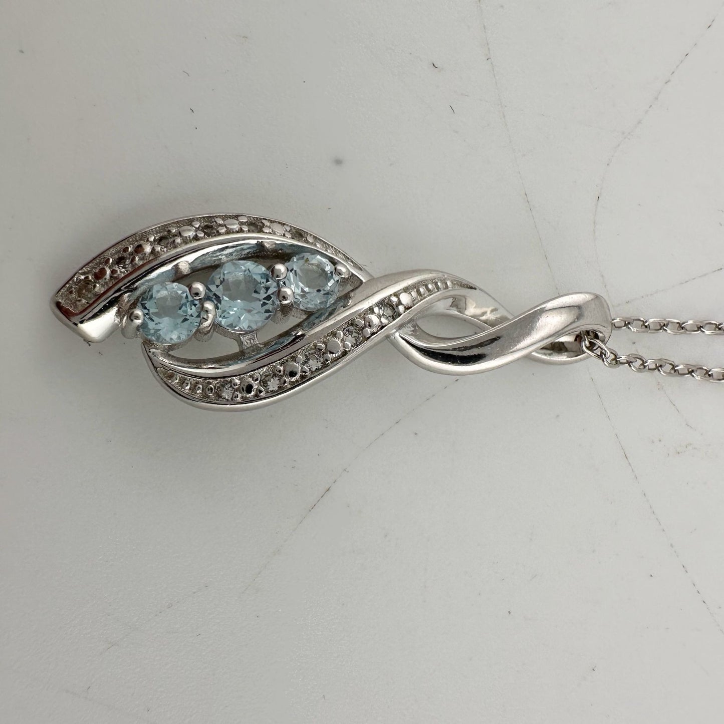 Blue Topaz Swirling Ribbon Necklace with Diamond Accent