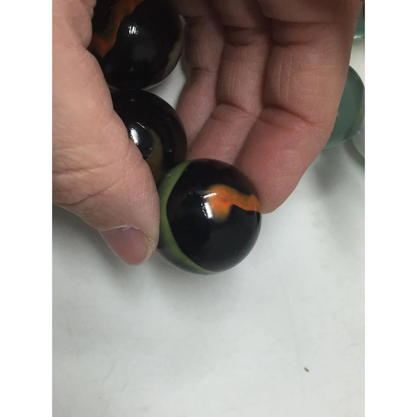 VINTAGE BLACK SHOOTER MARBLES WITH WHITE, YELLOW AND ORANGE SWIRLS - A+ Stuff - Collectibles - A+ Stuff