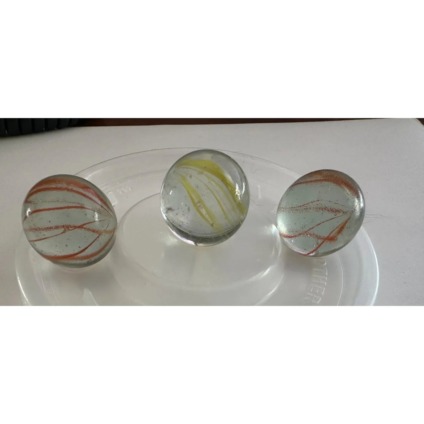 Vintage Clear Glass Shooter Marbles with Yellow and Orange Swirl Design - A+ Stuff - Collectibles - A+ Stuff