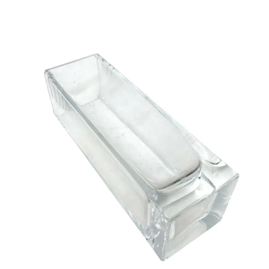 Rectangular clear glass block on white background, minimalist modern decor piece