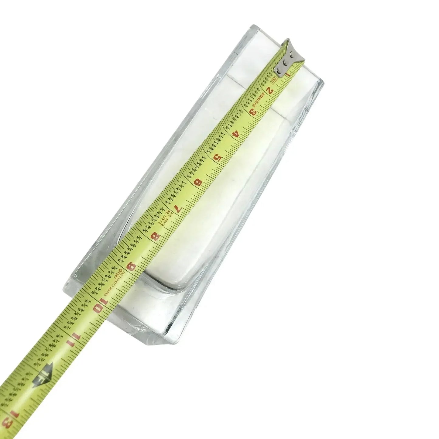 Rectangular glass container measured with a tape measure on a white background