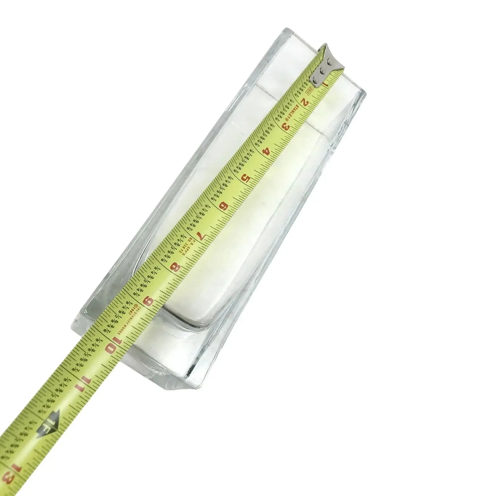 Rectangular glass container measured with a tape measure on a white background