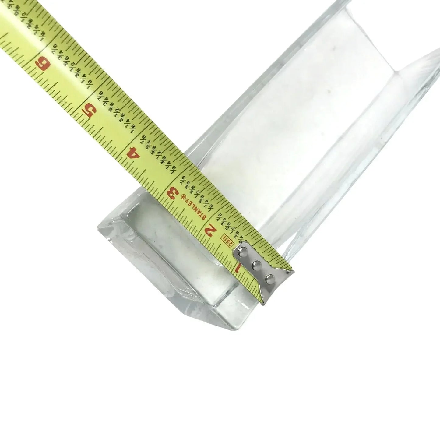 Measuring rectangular clear glass vase with tape measure on white background