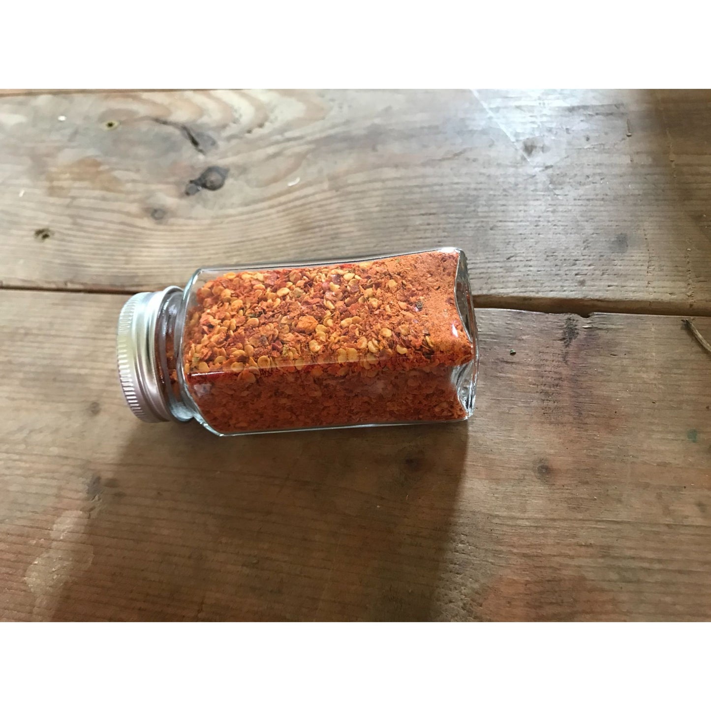 Dried and crushed Red Chili peppers to add a kick!  No other ingredients.