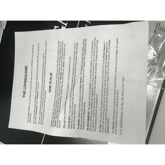 Photo of 'The Loving Game' board game instructions page with how-to-play directions.